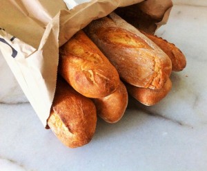 a bag of French loaves found in a dumpster dive by the owner of zero-waste-home--shows first paper bag she brought home from a grocery store in six years